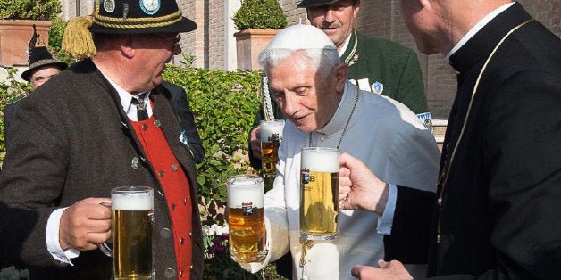 CORRECTS AGE OF POPE EMERITUS BENEDICT XVI - CORRECTS LOCATION OF THE BIRTHDAY PARTY TO VATICAN GARDENS - RESENDING TO PROVIDE AN ALTERNATIVE CROP OF OSS103 - Pope Emeritus Benedict XVI, center, toasts for his 88th birthday with Monsignor Georg Gaenswein, right, and members of a group from his hometown Bavaria region, in the Vatican gardens, Thursday, April 16, 2015. (L'Osservatore Romano/Pool Photo via AP)