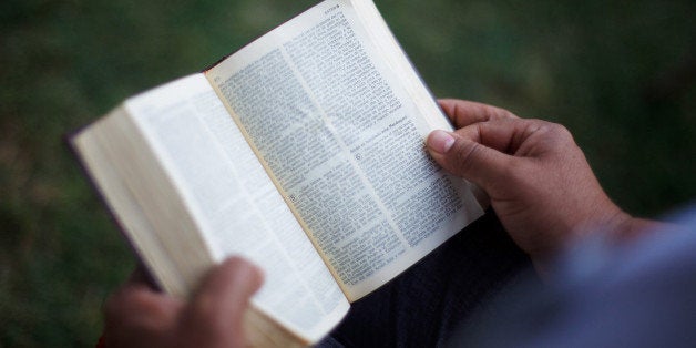 PHOENIX, AZ - APRIL 25: A protester reads the Bible before the start of a vigil for those who oppose Arizona's Immigration Law SB 1070 at the Arizona state Capitol April 25, 2012 in Phoenix, Arizona. Immigrant rights advocates are planning a day of protest in Phoenix on the same day the U.S. Supreme Court heard arguments over Arizona's 2010 immigration enforcement law. (Photo by Jonathan Gibby/Getty Images)