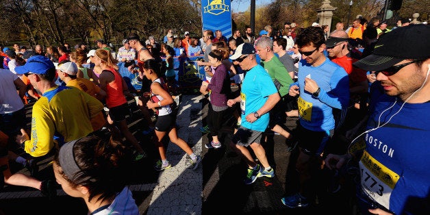 BOSTON, MA - APRIL 18: The first wave of runners takes off from the starting line during the B.A.A. 5k on April 18, 2015 in