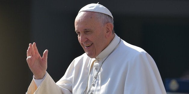 Pope Francis waves to faithful on April 15, 2014 upon his arrival on St. Peter's square at the Vatican to lead his weekly general audience. AFP PHOTO / VINCENZO PINTO (Photo credit should read VINCENZO PINTO/AFP/Getty Images)