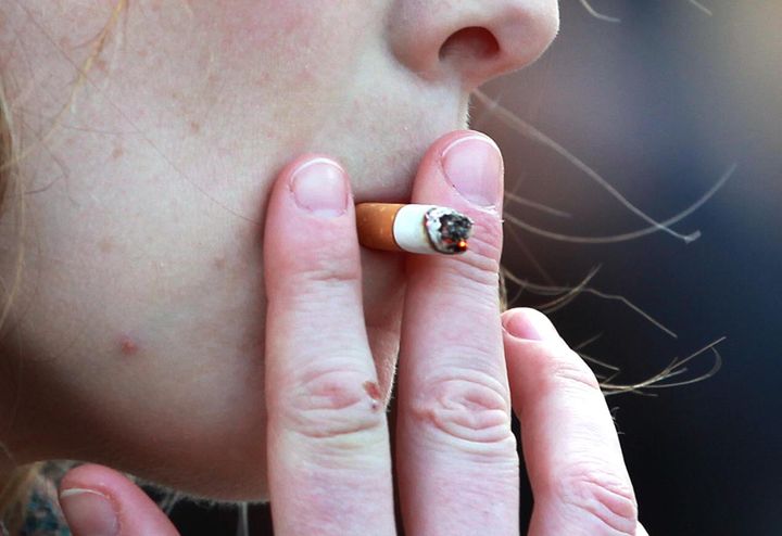File photo dated 21/02/14 of a woman smoking, as a study suggested that smokers are around 70\% more likely to suffer from depression and anxiety than ex-smokers and non-smokers.
