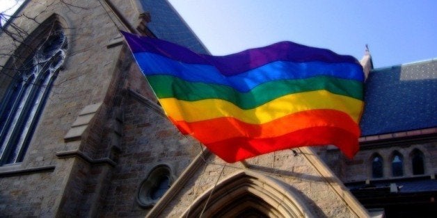 A rainbow/pride flag hanging from a local Botson Church in support of gay marriage and civil rights.