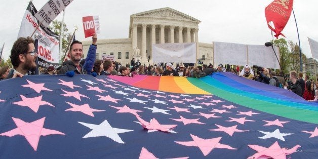 Protesters hold a pro-gay rights flag outside the US Supreme Court on April 25, 2015, countering the demonstrators who attended the March For Marriage in Washington, DC. The Supreme Court meets on April 28 to hear arguments whether same-sex couples have a constitutional right to wed in the United States, with a final decision expected in June. AFP PHOTO/PAUL J. RICHARDS (Photo credit should read PAUL J. RICHARDS/AFP/Getty Images)