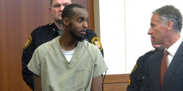 FILE - In this Feb. 25, 2015 file photo, Abdirahman Sheik Mohamud, left, speaks with his defense attorney, Sam Shamansky, during a hearing to set bond on charges of money laundering and providing support for terrorism in Columbus, Ohio. A Thursday, April 16 indictment says Mohamud left the country a year ago to train and fight with terrorists in Syria. The indictment says Mohamud, who was arrested in Columbus earlier this year, weighed which extremist group in Syria was more effective before his travels. (AP Photo/Andrew Welsh-Huggins)