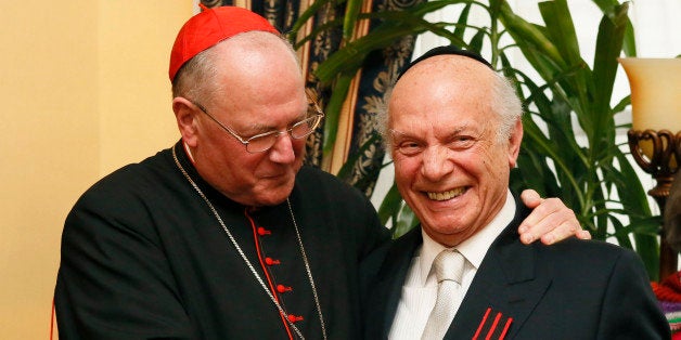 IMAGE DISTRIBUTED FOR THE APPEAL OF CONSCIENCE FOUNDATION - Cardinal Timothy Dolan of the Archdiocese of New York, awards Rabbi Arthur Schneier, Senior Rabbi of Park East Synagogue and the Founder and President of the Appeal of Conscience Foundation, a Papal Knighthood, as a Knight of St. Sylvester by Pope Francis, at the Official Residence of the Permanent Observer of the Holy See to the United Nations, on Monday, April 27, 2015 in New York. (Photo by Stuart Ramson/Invision for the Appeal of Conscience Foundation/AP Images)