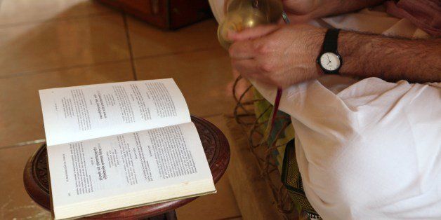 A Krishna devotee reads the Bhagavad-gita, Hare Krishna's movement Holy Book, during a ceremony held in the living room of a house located in the town of Aguacaliente, Cartago province, about 30 kilometers east of San Jose. The Costa Rican members of the Hare Krishna movement meet every Sunday in this house located in the town of Aguacaliente, Cartago province, about 30 kilometers east of San Jose, to sing in front of Krishna's altar and to read the Bhagavad-gita, their Holy Book. AFP PHOTO / Mayela LOPEZ (Photo credit should read MAYELA LOPEZ/AFP/Getty Images)