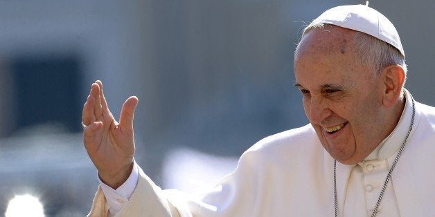 Pope Francis salutes the crowd as he arrives for his weekly general audience in St Peter's square at the Vatican on April 22, 2015. AFP PHOTO / FILIPPO MONTEFORTE (Photo credit should read FILIPPO MONTEFORTE/AFP/Getty Images)