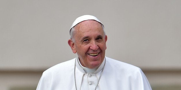 Pope Francis smiles as he arrives to lead his open-air weekly audience in St. Peter's Square on April 29, 2015 at the Vatican. AFP PHOTO / VINCENZO PINTO (Photo credit should read VINCENZO PINTO/AFP/Getty Images)