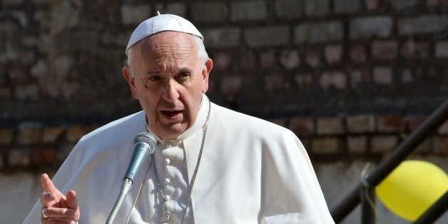Pope Francis gestures as he speaks to a crowd during his visit at Santa Maria Regina Pacis church on May 3, 2015, in Ostia, s