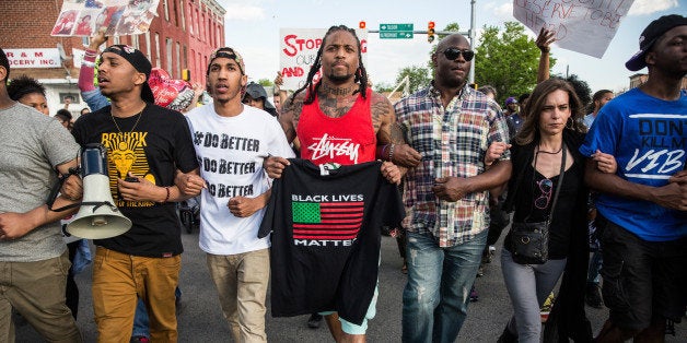 BALTIMORE, MD - MAY 02: Protesters march from City hall to the Sandtown neighborhood May 2, 2015 in Baltimore, Maryland. Freddie Gray, 25, was arrested for possessing a switch blade knife April 12 outside the Gilmor Houses housing project on Baltimore's west side. According to Gray's attorney, Gray died a week later in the hospital from a severe spinal cord injury he received while in police custody. State attorney Marilyn Mosby of Maryland announced that charges would be brought against the six police officers who arrested Gray. (Photo by Andrew Burton/Getty Images)