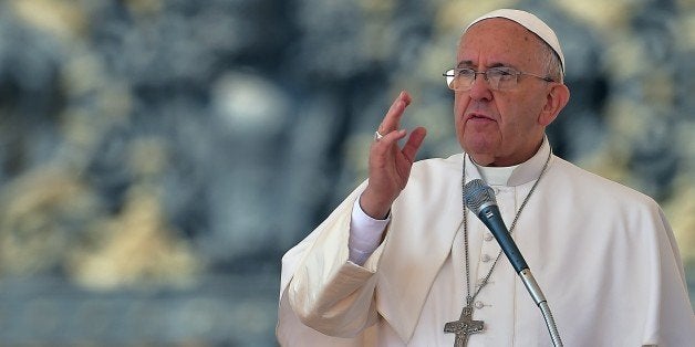 Pope Francis blesses the faitfhul on April 15, 2014 during his weekly general audience at the Vatican. AFP PHOTO / VINCENZO PINTO (Photo credit should read VINCENZO PINTO/AFP/Getty Images)