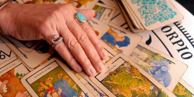 ** ADVANCE FOR SUNDAY, AUG. 26 ** Psychic and Tarot card reader Otis Biggs reads a spread of Tarot cards as a positive sign f