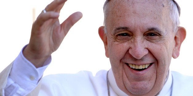 Pope Francis salutes the crowd as he arrives for his weekly general audience in St Peter's square at the Vatican on April 22, 2015. AFP PHOTO / FILIPPO MONTEFORTE (Photo credit should read FILIPPO MONTEFORTE/AFP/Getty Images)