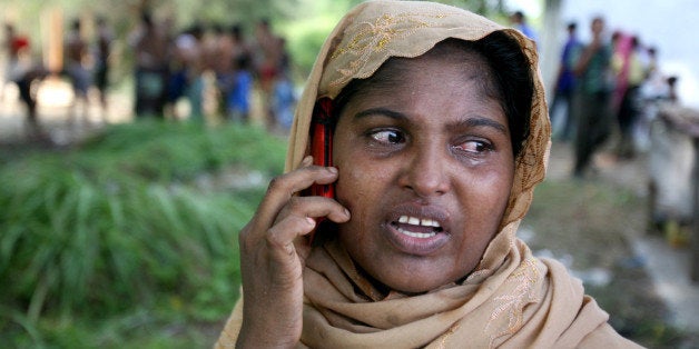 An ethnic Rohingya woman cries as she uses her phone to call a relative back home, at a temporary shelter in Langsa, Aceh province, Indonesia, Saturday, May 16, 2015. Boats filled with more than 2,000 desperate and hungry refugees from Myanmar and Bangladesh have arrived in Thailand, Malaysia and Indonesia in recent weeks, and thousands more migrants are believed to be adrift at sea after a crackdown on human traffickers prompted captains and smugglers to abandon their boats. (AP Photo/Binsar Bakkara)