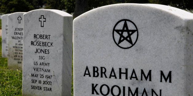 In this Aug. 20, 2010 photo, the tombstone for Pfc. Abraham Kooiman, a World War II veteran who died in 2002, is shown inscribed with a Wiccan religious symbol at Arlington National Cemetery in Arlington, Va. As rancor swirls around the issue of whether a mosque and Islamic cultural center should be built two blocks from the New York site where the destroyed Twin Towers stood, Americans are being forced to examine just how tolerant they are _ or are not. (AP Photo/Alex Brandon)