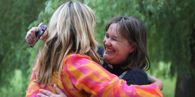 YORK, ENGLAND - JULY 14: The Revd Emma Percy(R) embraces Revd Jody Stowell after the Church of England General Synod gave their backing to to the ordination of women bishops at York University on July 14, 2014 in York, England. Members and officers of the Church of England's General Synod have voted in favour to introduce women bishops. The first women bishops could be announced and ordained within the next year. (Photo by Christopher Furlong/Getty Images)