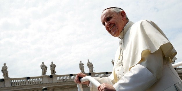 Pope Francis smiles as he leaves St Peter's square at the end of his weekly general audience at the Vatican on May 27, 2015.