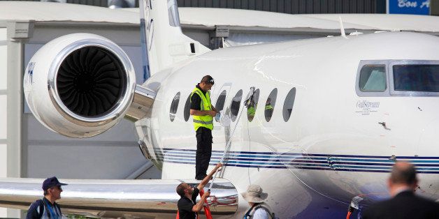 Gulfstream emlployees clean a Gulfstream G650 business jet, at the 50th Paris Air Show at Le Bourget airport, north of Paris, Tuesday June 18, 2013. (AP Photo/Remy de la Mauviniere)
