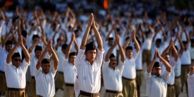 Volunteers of Hindu nationalist Rashtriya Swayamsevak Sangh (RSS), or the National Volunteers Force, perform yoga during a vista by their chief Mohan Bhagwat in Jammu, India, Sunday, Sept. 29, 2013. The RSS is parent organization of the opposition Bharatiya Janata party (BJP). (AP Photo/Channi Anand)