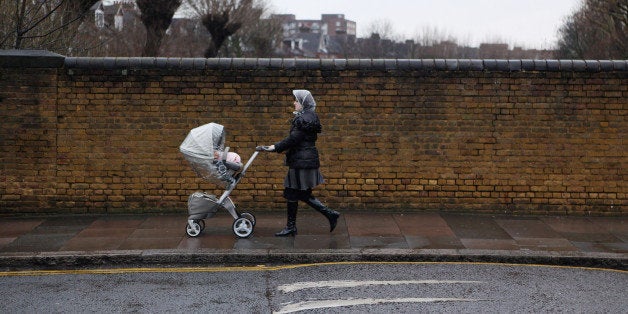 LONDON, ENGLAND - JANUARY 12: A woman pushes a pram in the Stamford Hill area of north London on January 12, 2011 in London, England. The residents of Stamford Hill are predominately Hasidic Jewish and only New York has a larger community of Hasidic Jews outside Israel. The area contains approximately 50 synagogues and many shops cater specifically for the needs of Orthodox Jews. (Photo by Oli Scarff/Getty Images)