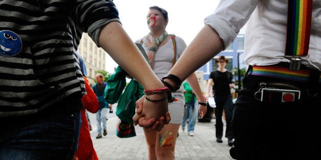 RALEIGH, NC - MAY 14: Bronwgn Sheppard, 17, marches behind two females holding hands in protest of the recently passed Constitutional Amendment One in the North Carolina primary on May 14, 2012 in Raleigh, North Carolina. The activists were asking for a repeal of the Amendment which defines marriage solely as a union between a man and a woman, becoming the latest state to prevent same-sex marriages. (Photo by Sara D. Davis/Getty Images)