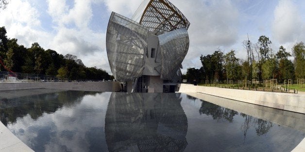 View of the Louis Vuitton Foundation designed by Canadian-American architect Frank Gehry in the Bois de Boulogne in Paris on October 17, 2014. The building which takes the form of a sailboat amongst the trees of the Bois de Boulogne, consists of twelve huge sails glass, and is part of the long tradition of architectural glass such as the Grand Palace. AFP PHOTO / BERTRAND GUAY (Photo credit should read BERTRAND GUAY/AFP/Getty Images)