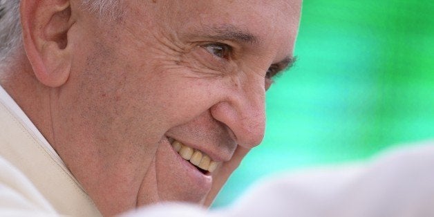 Pope Francis greets the crowd as he arrives for an audience with the participants at the Convention of Rome Diocese at St Peter's square on June 14, 2015 at the Vatican. AFP PHOTO / FILIPPO MONTEFORTE (Photo credit should read FILIPPO MONTEFORTE/AFP/Getty Images)