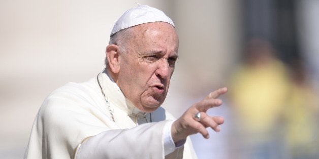 Pope Francis greets the crowd as he arrives for his general audience at St Peter's square on June 10, 2015 at the Vatican. AFP PHOTO / FILIPPO MONTEFORTE (Photo credit should read FILIPPO MONTEFORTE/AFP/Getty Images)