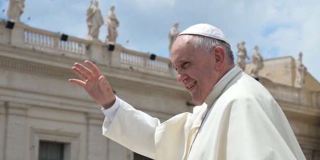 Pope Francis greets the crowd at the end of his weekly general audience at St Peter's square on June 17, 2015 at the Vatican. AFP PHOTO / ALBERTO PIZZOLI (Photo credit should read ALBERTO PIZZOLI/AFP/Getty Images)