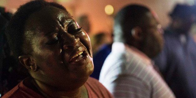 Lisa Doctor joins a prayer circle down the street from the Emanuel AME Church early Thursday, June 18, 2015 following a shooting Wednesday night in Charleston, S.C. (AP Photo/David Goldman)