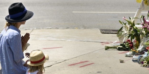 A woman prays at a makeshift memorial near the Emanuel AME Church June 18, 2015 in Charleston, South Carolina, after a mass s