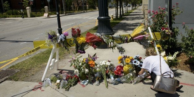 A woman places flowers at a makeshift memorial near the Emanuel AME Church June 18, 2015 in Charleston, South Carolina, after