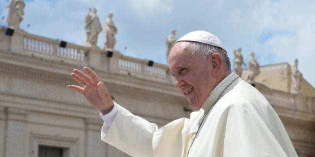 Pope Francis greets the crowd at the end of his weekly general audience at St Peter's square on June 17, 2015 at the Vatican. AFP PHOTO / ALBERTO PIZZOLI (Photo credit should read ALBERTO PIZZOLI/AFP/Getty Images)