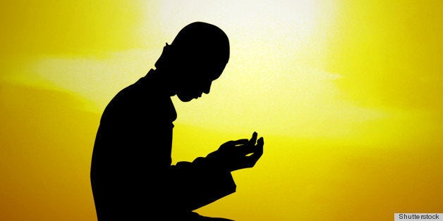 silhouette of a muslim praying...