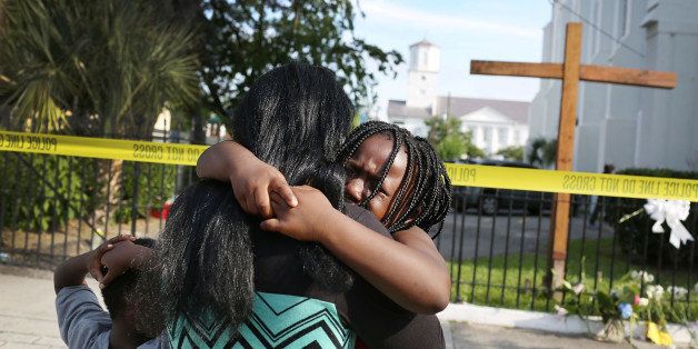 CHARLESTON, SC - JUNE 19: Kearston Farr comforts her daughter, Taliyah Farr,5, as they stand in front of the Emanuel African Methodist Episcopal Church after a mass shooting at the church that killed nine people of June 19, 2015. A 21-year-old white gunman is suspected of killing nine people during a prayer meeting in the church, which is one of the nation's oldest black churches in Charleston. (Photo by Joe Raedle/Getty Images)