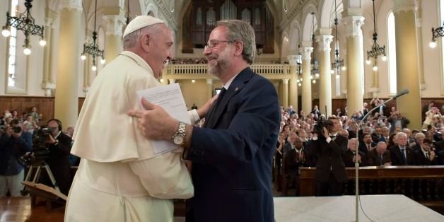 Pope Francis shakes hands with Eugenio Bernardini, the Moderator of the Waldensian Church, during the first ever visit of a pope to the Waldensian evangelical church, in Turin, northern Italy, Monday, June 22, 2015. Pope Francis asked forgiveness Monday for the Catholic Church's persecution of members of this small evangelical church in Italy whose leader was excommunicated and followers branded as heretics during the Middle Ages. (L' Osservatore Romano/Pool Photo via AP)