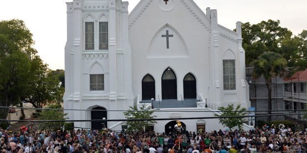 People que to lay flowers at Emanuel AME Church in Charleston, South Carolina on June 19, 2015. Police captured the white suspect in a gun massacre at one of the oldest black churches in the United States, the latest deadly assault to feed simmering racial tensions. Police detained 21-year-old Dylann Roof, shown wearing the flags of defunct white supremacist regimes in pictures taken from social media, after nine churchgoers were shot dead during bible study on June 17. AFP PHOTO/MLADEN ANTONOV (Photo credit should read MLADEN ANTONOV/AFP/Getty Images)
