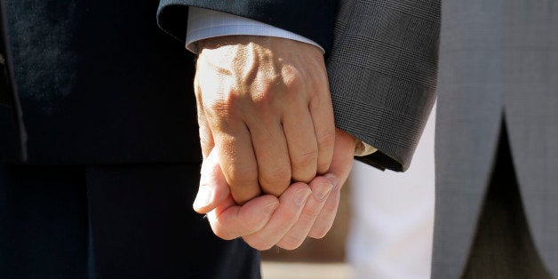 Texas marriage plaintiffs Vic Holmes, left, and partner Mark Phariss, right, hold hands on the steps of the Texas Capitol dur