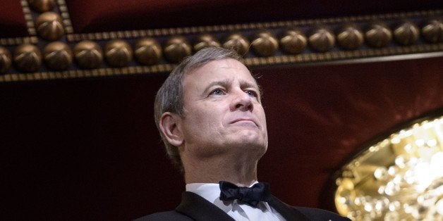 Chief Justice of the US Supreme Court John Roberts listens during the 37th Kennedy Center Honors at the Kennedy Center December 7, 2014 in Washington, DC. Artists from various mediums were honored for their contribution to arts in the United States. AFP PHOTO/Brendan SMIALOWSKI (Photo credit should read BRENDAN SMIALOWSKI/AFP/Getty Images)