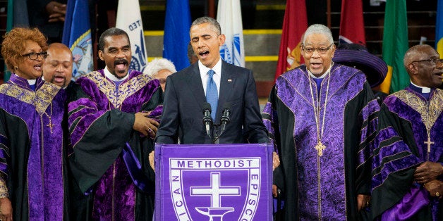 President Barack Obama sings "Amazing Grace" during services honoring the life of Rev. Clementa Pinckney, Friday, June 26, 2015, at the College of Charleston TD Arena in Charleston, S.C.. Pinckney was one of the nine people killed in the shooting at Emanuel AME Church last week in Charleston. (AP Photo/David Goldman)