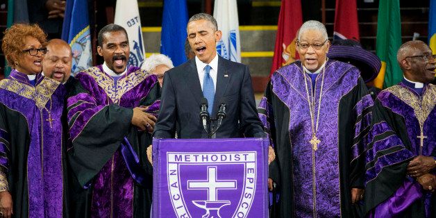 President Barack Obama sings "Amazing Grace" during services honoring the life of Rev. Clementa Pinckney, Friday, June 26, 2015, at the College of Charleston TD Arena in Charleston, S.C.. Pinckney was one of the nine people killed in the shooting at Emanuel AME Church last week in Charleston. (AP Photo/David Goldman)