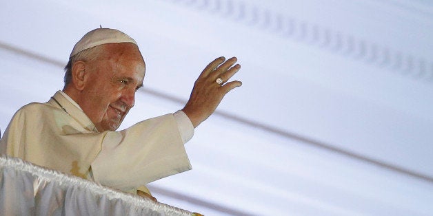 Pope Francis blesses the faithful gathered at independence square in Quito, Ecuador, Monday, July 6, 2015. After a Mass in the port city of Guayaquil where hundreds of thousands listened to Pope Francis, he returned to the capital city of Quito, where he met with President Rafael Correa. Francis is making his first visit as pope to his Spanish-speaking neighborhood. He travels to three South American nations, Ecuador, Bolivia and Paraguay. (AP Photo/Dolores Ochoa)