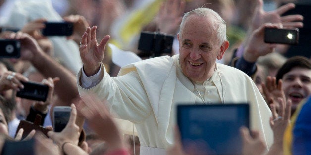 Pope Francis waves to the crowd as he arrives to celebrate a mass in Asuncion, Paraguay, Sunday, July 12, 2015. The pope arrived Friday afternoon in the Paraguayan capital of Asuncion on the final leg of his three-nation tour of South America's poorest countries that included Ecuador and neighboring Bolivia. (AP Photo/Natacha Pisarenko)