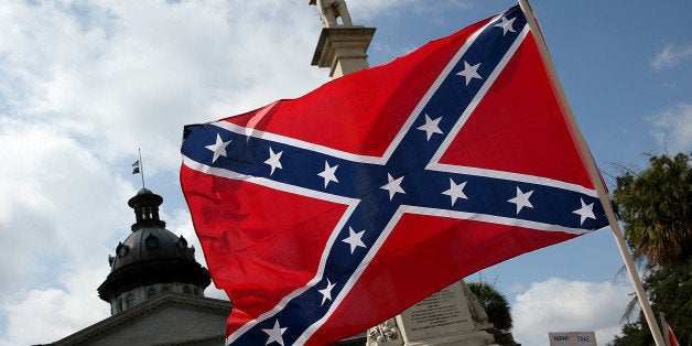 COLUMBIA, SC - JUNE 27: Demonstrators protest at the South Carolina State House calling for the Confederate flag to remain on the State House grounds June 27, 2015 in Columbia, South Carolina. Earlier in the week South Carolina Gov. Nikki Haley expressed support for removing the Confederate flag from the State House grounds in the wake of the nine murders at Mother Emanuel A.M.E. Church in Charleston, South Carolina. (Photo by Win McNamee/Getty Images)