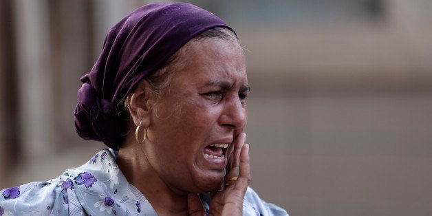 An Egyptian woman mourns over the death of 1st Lt. Mohammed Adel Abdel Azeem, killed in Wednesday's attack by Islamic militan