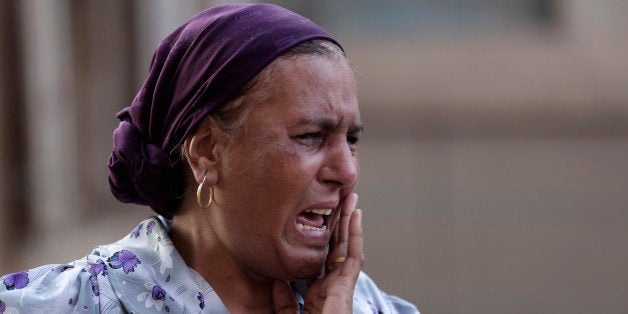 An Egyptian woman mourns over the death of 1st Lt. Mohammed Adel Abdel Azeem, killed in Wednesday's attack by Islamic militants in the Sinai, during the funeral procession at his home village Tant Al Jazeera in Qalubiyah, north of Cairo, Egypt, Thursday, July 2, 2015. Islamic State-linked militants launched an unprecedented wave of attacks in northern Sinai on Wednesday, setting off the fiercest fighting the peninsula has seen in decades and undermining government efforts to stem the insurgency. (AP Photo/Hassan Ammar)