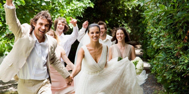 Wedding party running in garden