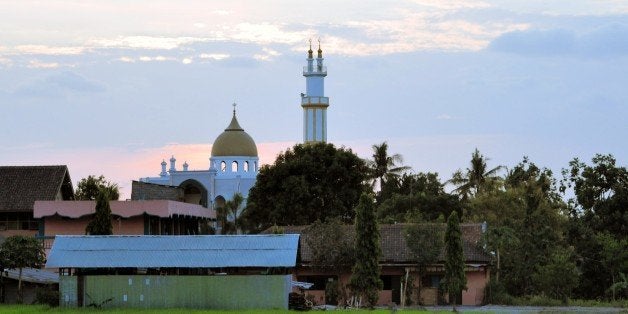 A Muslim Mosque is standing in green almost ripe ricefields in the countryside of Yogyakarta, Indonesiea