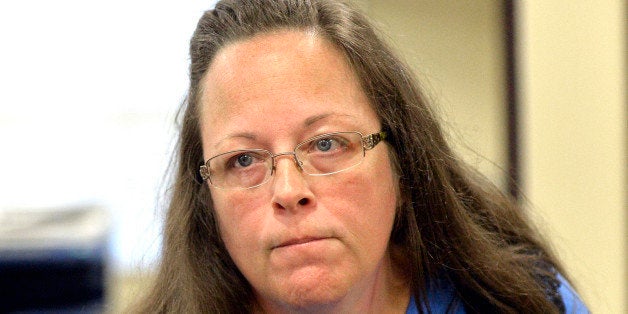 Rowan County Clerk Kim Davis listens to a customer following her office's refusal to issue marriage licenses at the Rowan County Courthouse in Morehead, Ky., Tuesday, Sept. 1, 2015. Although her appeal to the U.S. Supreme Court was denied, Davis still refuses to issue marriage licenses. (AP Photo/Timothy D. Easley)