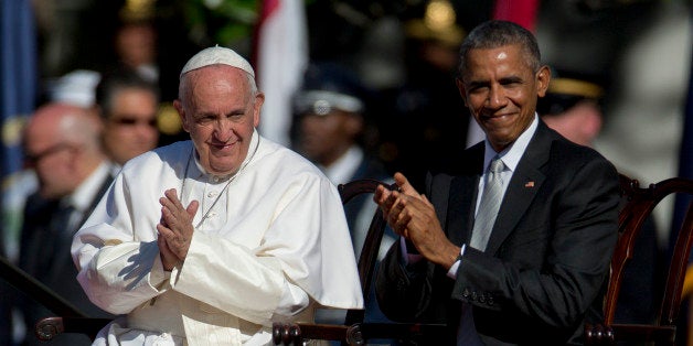 Pope Francis, left, and U.S. President Barack Obama clap after listening to a choir during an arrival ceremony on the South L